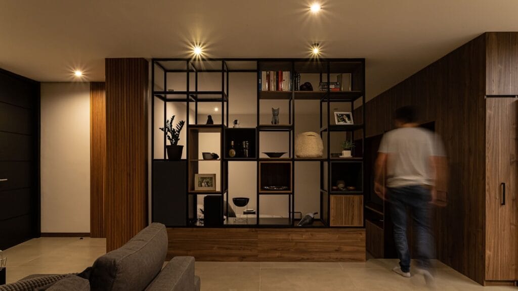 a man is walking through a living room