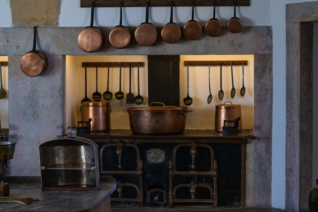 a kitchen with pots and pans hanging on the wall