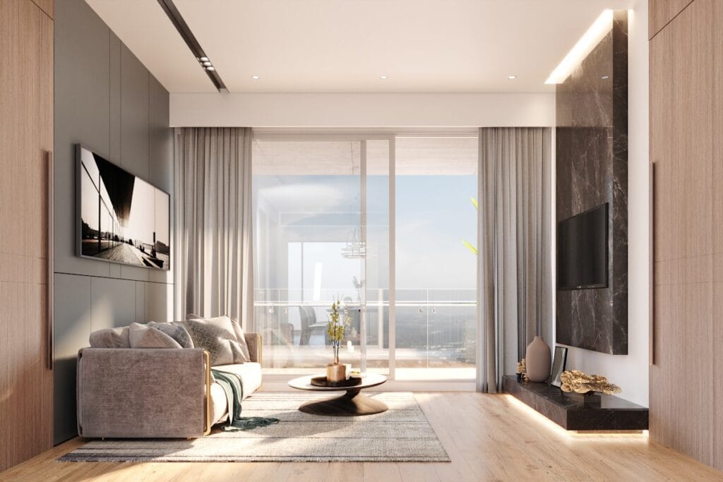 Modern living room with large window and ocean view.