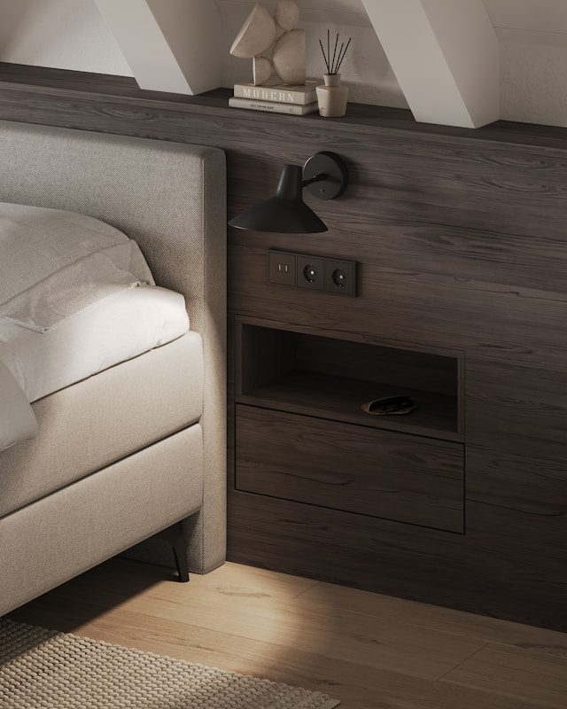 A bedroom with a bed, nightstand, and window