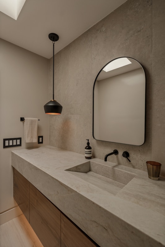 Modern bathroom vanity with integrated sink and black faucet.