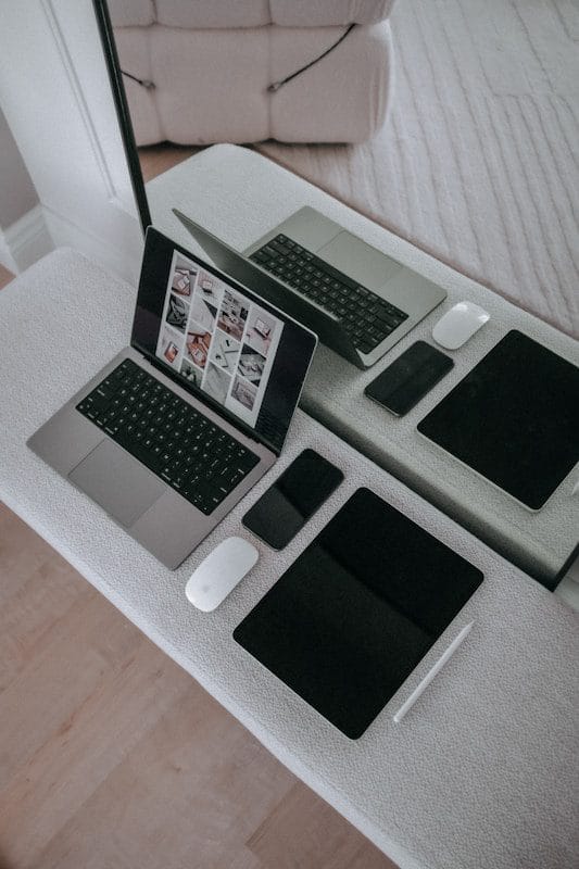 A laptop computer sitting on top of a white table
